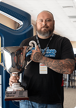 A photo of Kenny Ziglar the second holding the Best of Show trophy